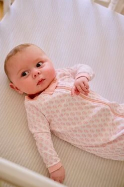 Lake Baby Sleeper In English Rose Blockprint 8 Lake Baby Sleeper In English Rose Blockprint -Lake Shop LAKE Webcrop Fall23 Lifestyle PimaFootedSleeper EnglishRoseBlockprint 0852